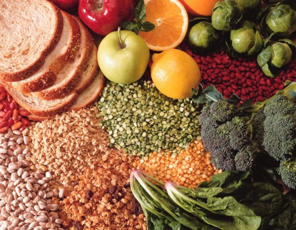 Bowl with fresh vegetables and grains on a table